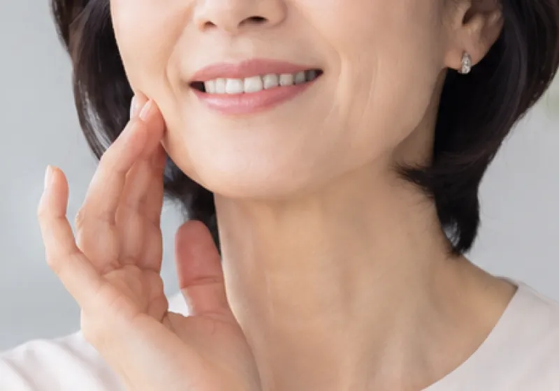 口元に手を添えて笑う女性